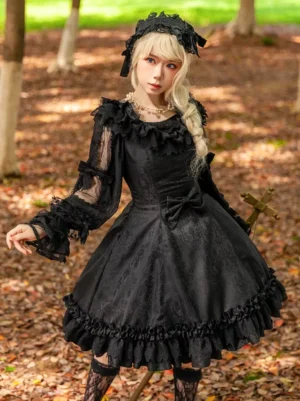 Black gothic lolita jumper dress with ruffled collar and lace-up back on model in park setting