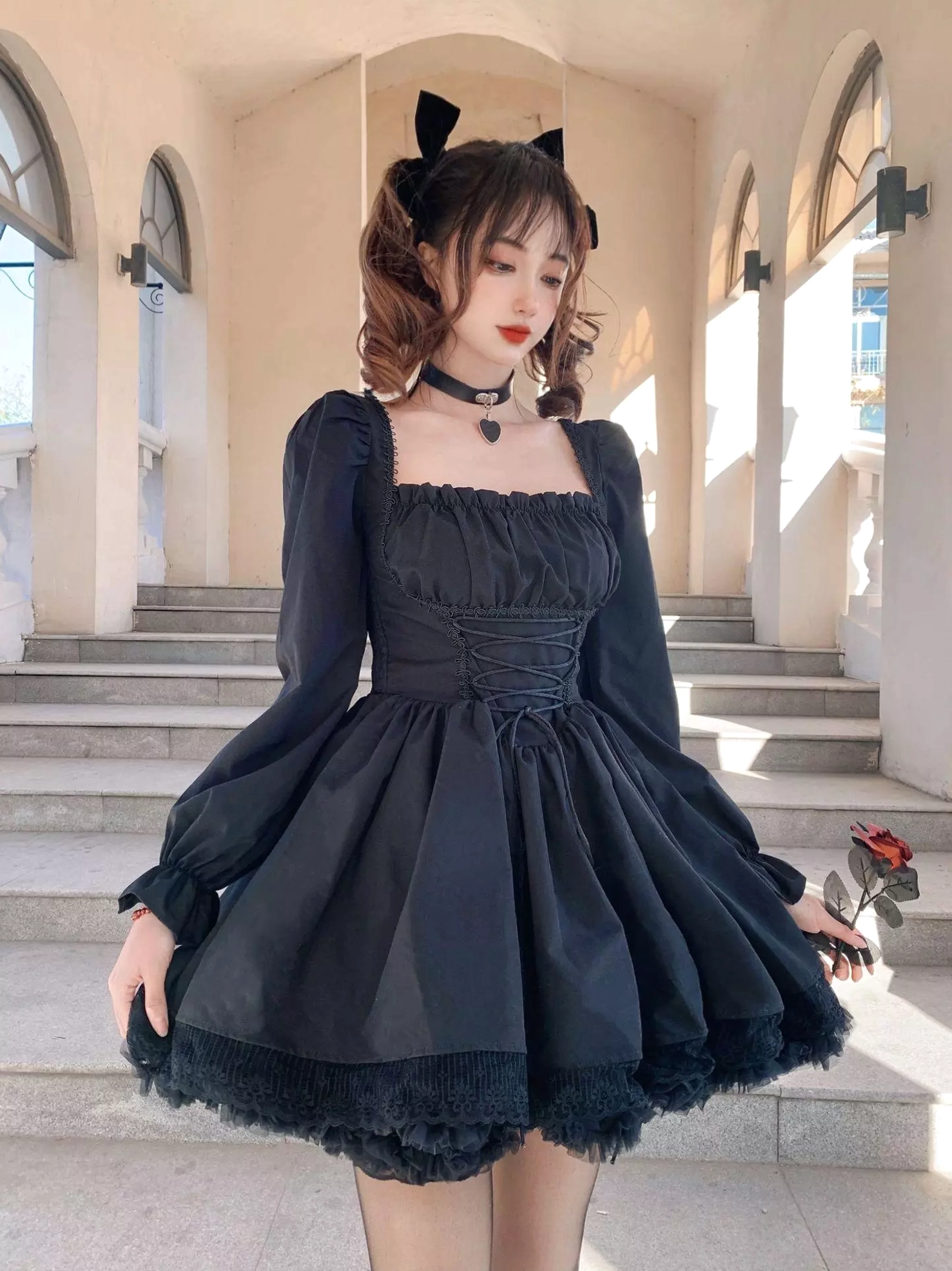 Black gothic lolita lace-up corset dress with square neckline, voluminous puff sleeves, and layered lace ruffle hem - full front view on model