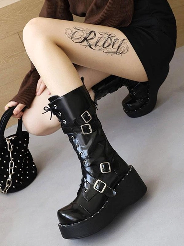 Female model wearing black Gothic Lolita platform boots lace-up design adjustable buckle straps casual coordinate