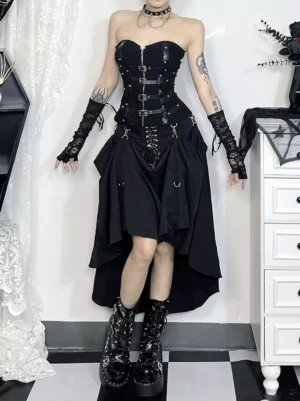Black gothic lolita high-low lace-up skirt with metal D-ring details front view studio setting checkered floor asymmetric hem