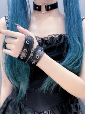 Black gothic lolita leather oversleeves with metal grommets worn on wrists, front half-body view showing metallic finish and zipper accent details on model with teal twin tails