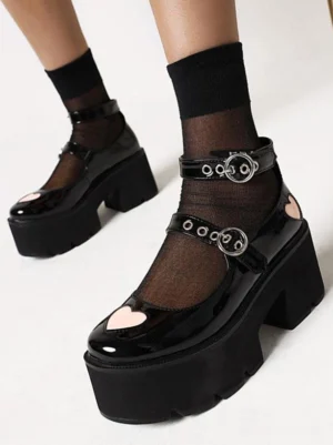 Black gothic lolita Mary Jane platform shoes front three-quarter view with heart toe decoration and double buckle ankle straps, worn with black sheer socks