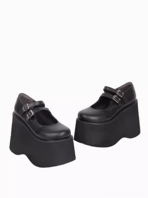 Side profile view of black punk lolita platform pumps with double buckle straps, wavy edge platform sole, and matte leather finish