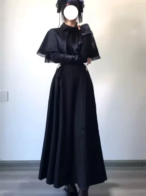 Black gothic lolita maxi dress with lace-trimmed capelet and lace-up corset bodice worn by model in front full-body view