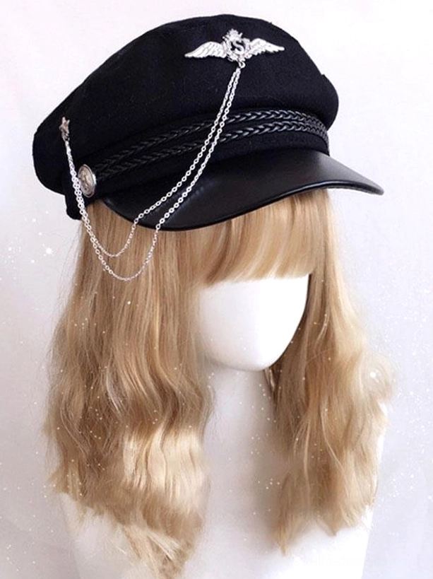 Black gothic lolita military newsboy cap with layered silver chain embellishment and wing brooch, front three-quarter view on mannequin with blonde curly wig