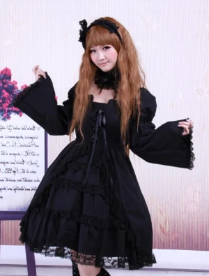Black Gothic Lolita OP dress front view featuring square neckline, lace-trimmed long sleeves, and layered ruffled skirt with bow accents