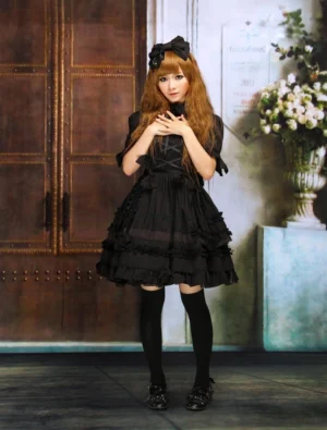Black gothic lolita one-piece dress with turndown collar tiered ruffles short puff sleeves front view on model