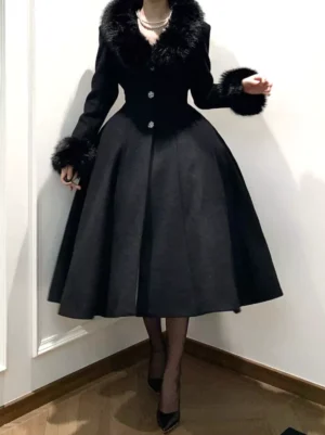 Black Gothic Lolita winter overcoat with faux fur collar and cuffs, front three-quarter view showing cinched waist, flared midi skirt, and crystal button details, worn with pearl necklace and black sheer stockings