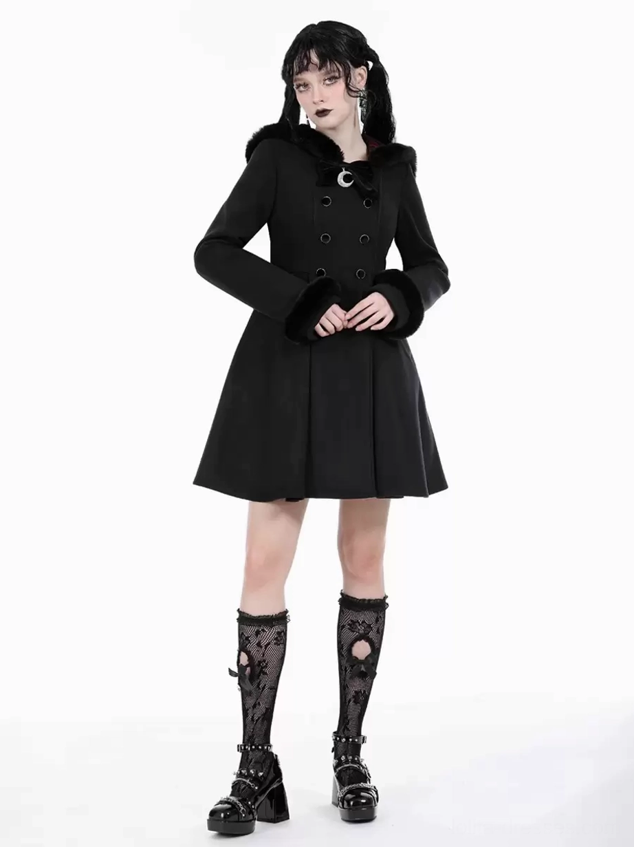Black Gothic Lolita overcoat straight-on full-body view with hands folded front, fur-trimmed cuffs and crescent moon collar buckle on twin-tail model