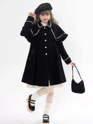 Black Gothic Sweet Lolita wool overcoat with detachable ruffled cape collar and white button closure, full-body front view on model wearing black beret and handbag