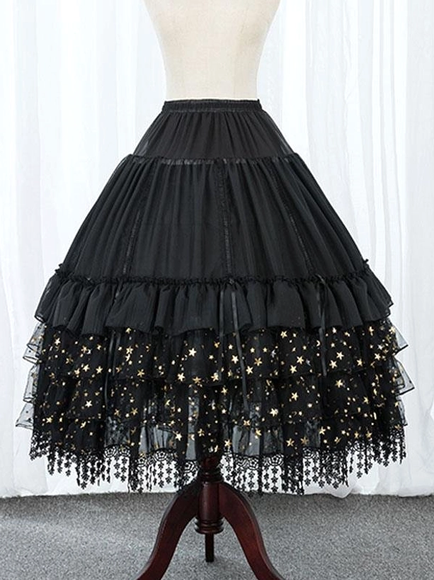 Black tiered Lolita petticoat front view with star print tulle hem tassel lace trim and cascading ruffled layers indoors