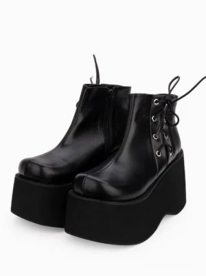 Black gothic lolita platform ankle boots pair display featuring chunky flatform sole, lace-up metal grommets, and smooth PU leather upper in three-quarter side view
