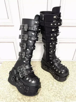 Side oblique angle of black Gothic Lolita platform boots showing studded buckle straps, thick platform sole, and knee-high shaft structure