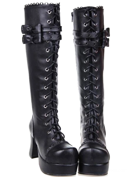 Pair of black Gothic Lolita platform boots showing lace-up front closure, decorative bow ankle strap, scalloped metal collar detail, and block platform heel - front paired view
