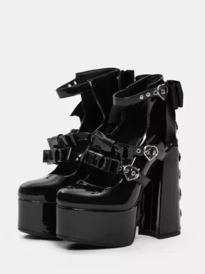 Black patent leather Gothic Lolita platform boots with heart-buckle straps and ankle bow front three-quarter display view