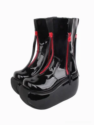 Pair of black patent leather Gothic Lolita platform boots front three-quarter view displaying dual red side zippers shiny patent finish and ultra thick platform sole design