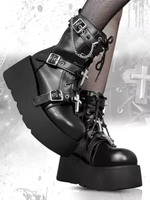 Black Gothic Lolita boots side profile view worn with fishnet stockings, showing lace-up front, ornate cross buckle decoration, and chunky platform heel construction