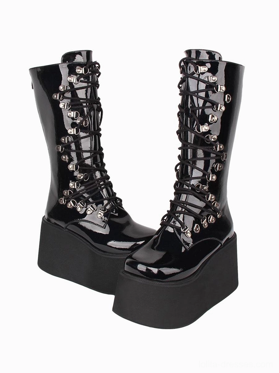 Gothic platform combat boots outer side three-quarter view showing all-black patent finish silver eyelet lacing and thick platform base construction