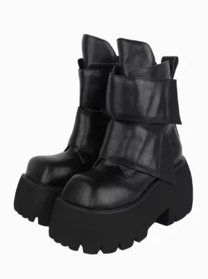 Black Gothic Lolita platform ankle boots with square toe and serrated thick outsole, front oblique view showing paired boots with wide wrap straps and tiered embellishment details