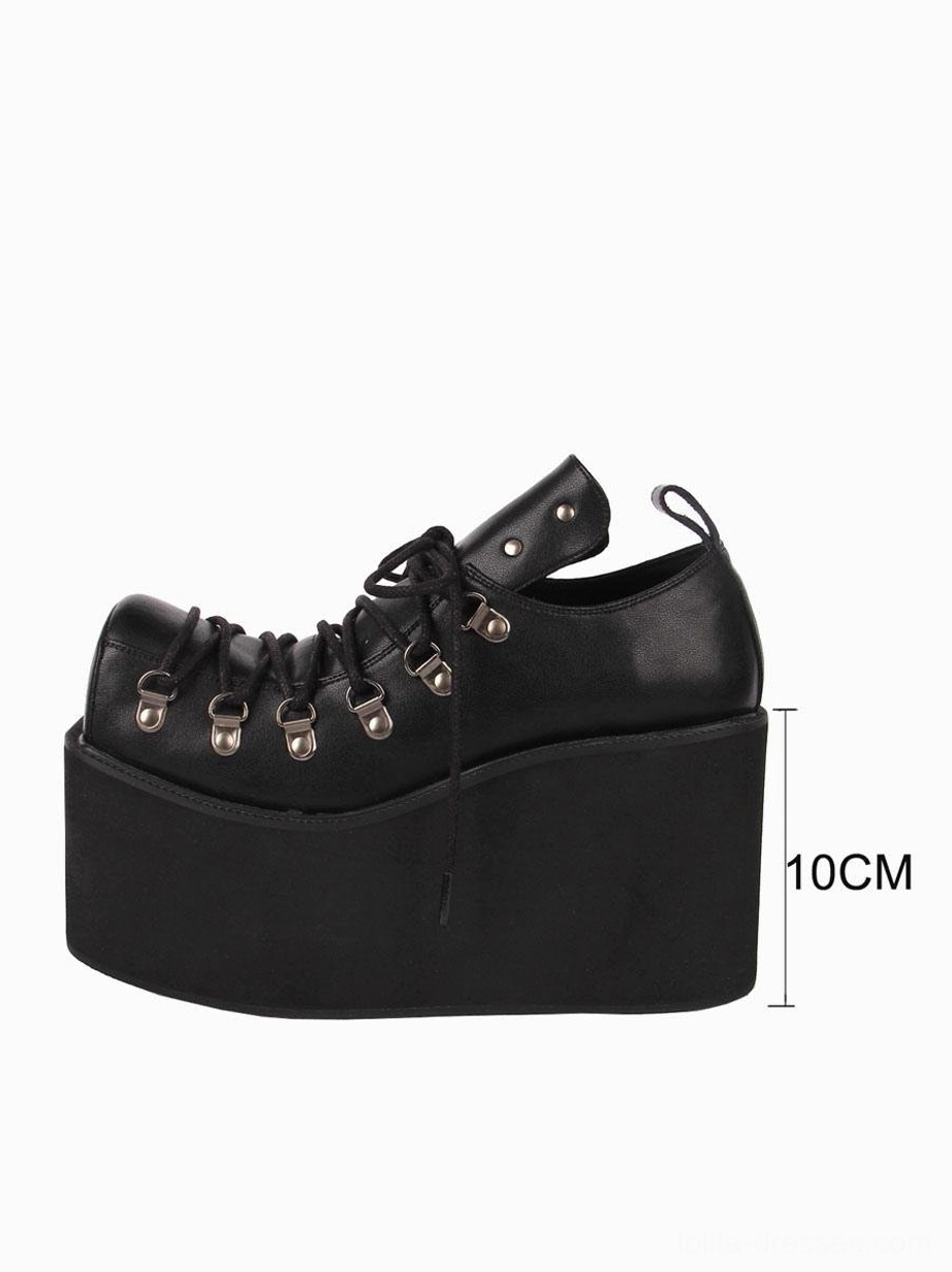 Black gothic lolita platform pump with 10cm wedge height, side profile view displaying matte PU leather, lace-up grommets construction and platform depth