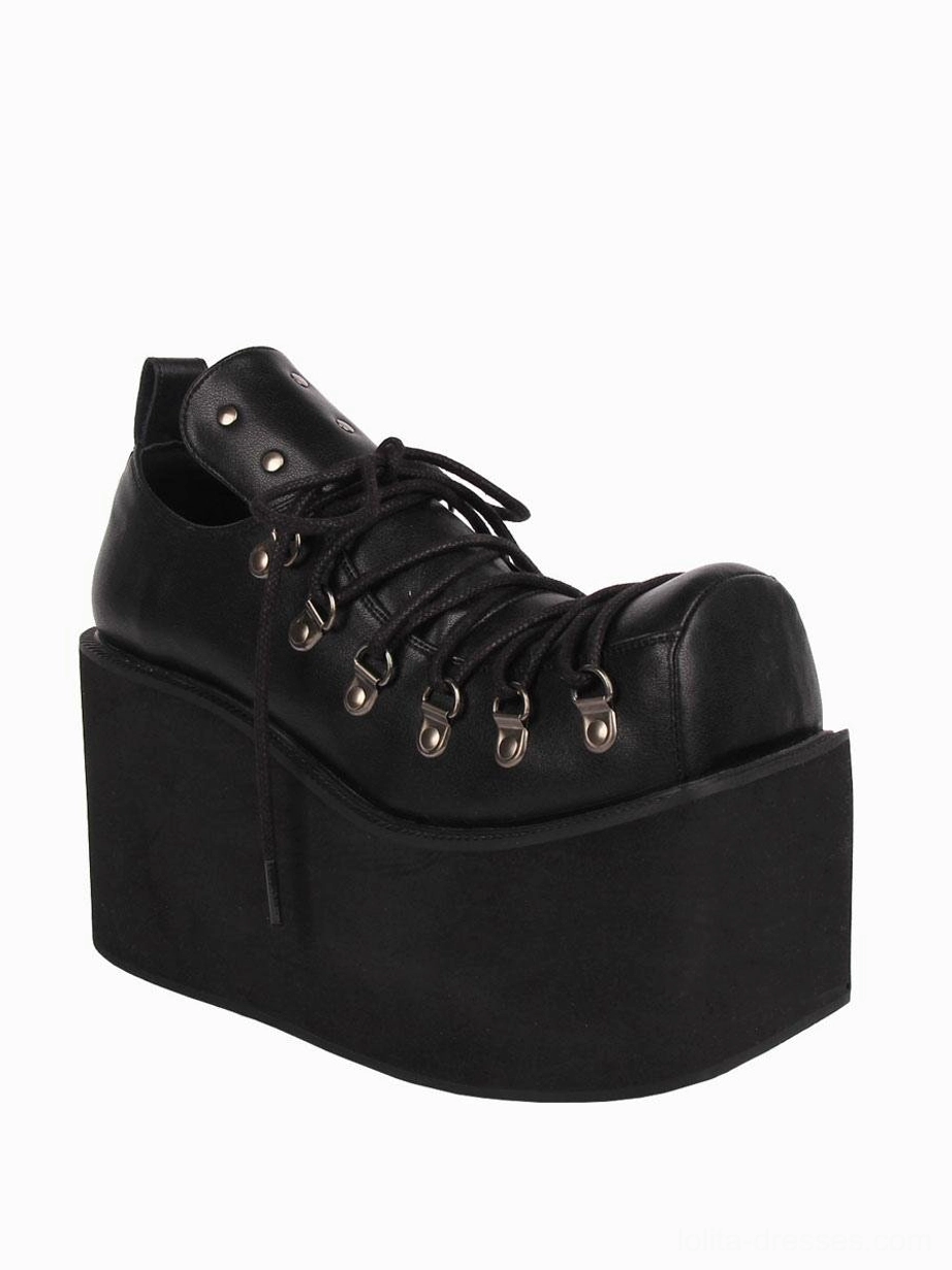 Single black gothic platform pump with high wedge sole, side three-quarter angle displaying metal eyelet details and matte PU leather finish