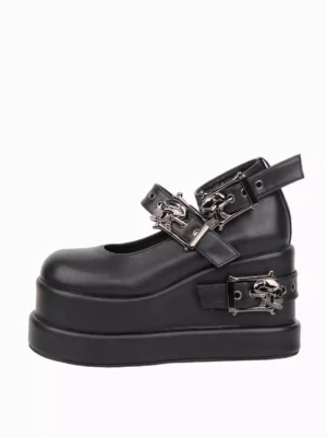 Single black Gothic Lolita platform pump left side three-quarter view showing 10cm hidden wedge heel and dual skull buckle straps