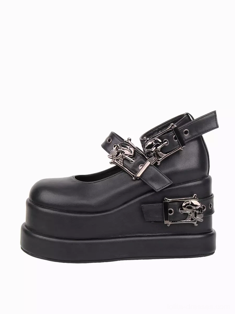 Single black Gothic Lolita platform pump left side three-quarter view showing 10cm hidden wedge heel and dual skull buckle straps