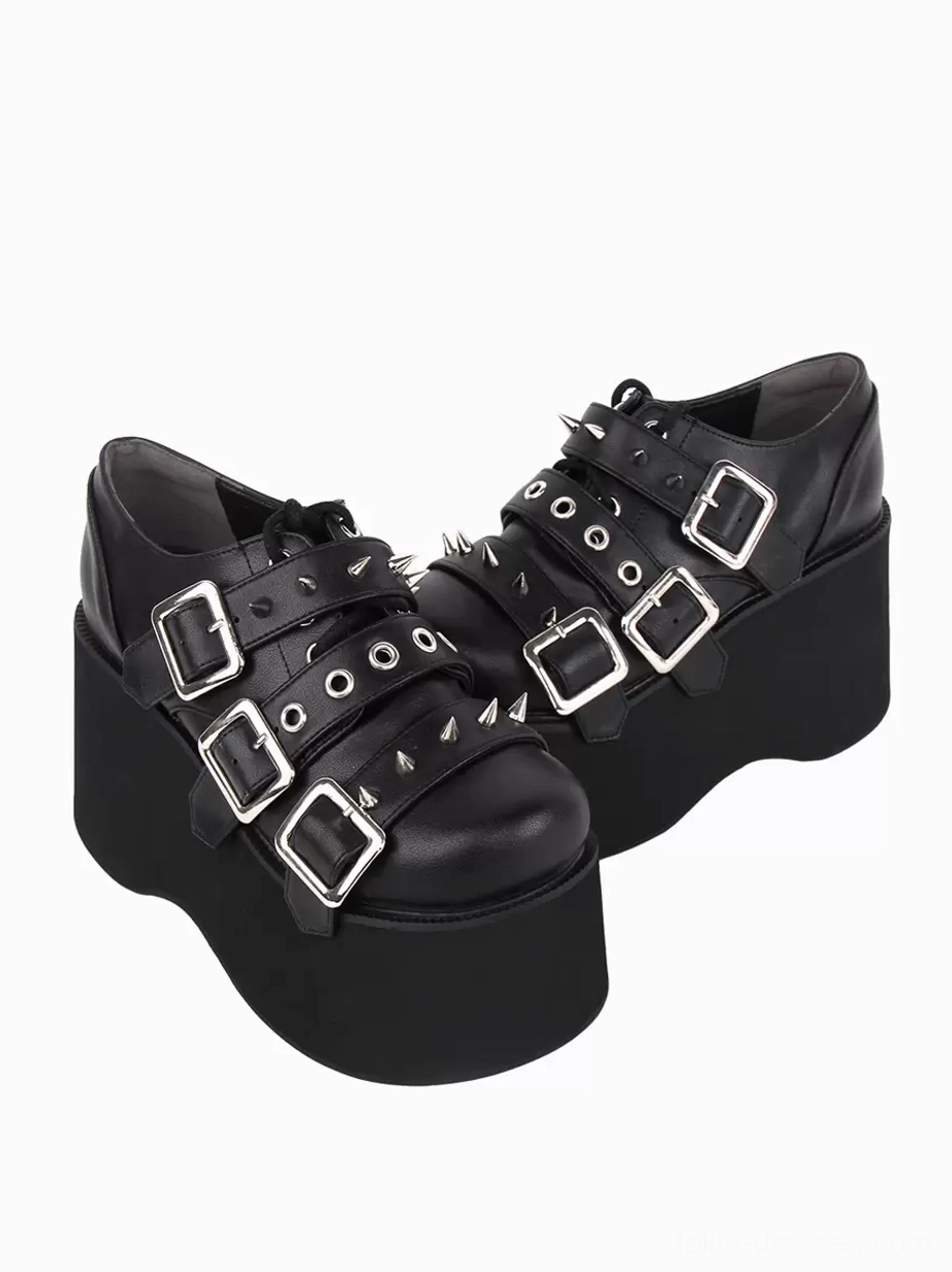Pair of black gothic lolita platform pumps featuring round toe and metallic studs, front top-down perspective displaying decorative grommet hardware and chunky platform sole