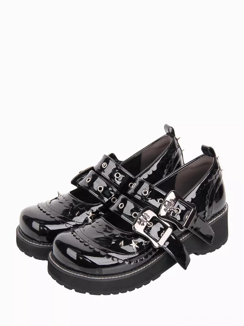Black gothic lolita platform pumps with metal spike studs and double adjustable buckle straps, shown from oblique top-down perspective on white background, displaying scalloped shoe edge detail and glossy patent leather finish