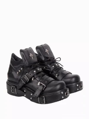 Black gothic lolita platform pumps side profile display featuring thick studded platform heel silver cross decoration and buckle straps on minimalist white backdrop