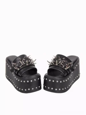 Flat lay overhead top-down view of black platform lolita sandals showing studded sole edge and decorative spike buckle trim details pure white background