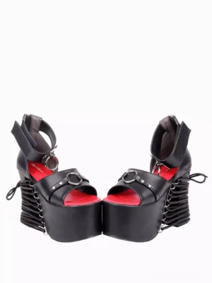 Pair of black Gothic Lolita platform sandals front angle view lace-up back metal buckle details red insole