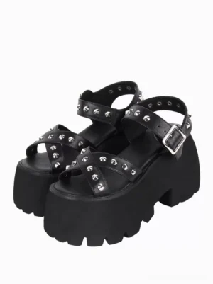 Black Gothic Lolita platform sandals with silver pyramid studs on all straps, front three-quarter view showcasing peep toe design and chunky serrated lug sole on white background