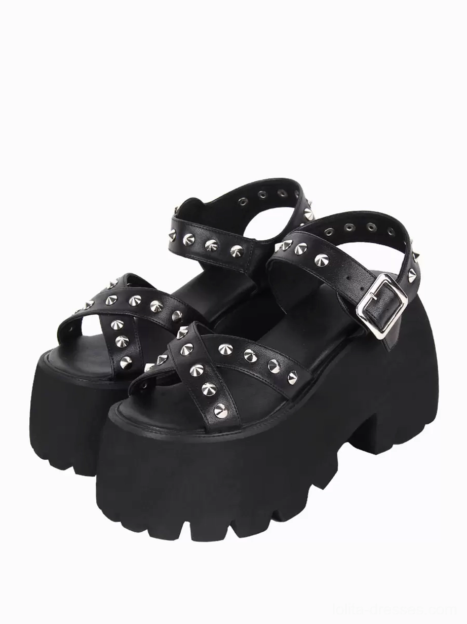 Black Gothic Lolita platform sandals with silver pyramid studs on all straps, front three-quarter view showcasing peep toe design and chunky serrated lug sole on white background