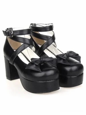 Black lolita platform shoes with glossy PU leather, buckle cross straps, and thick platform sole, angled front view pair
