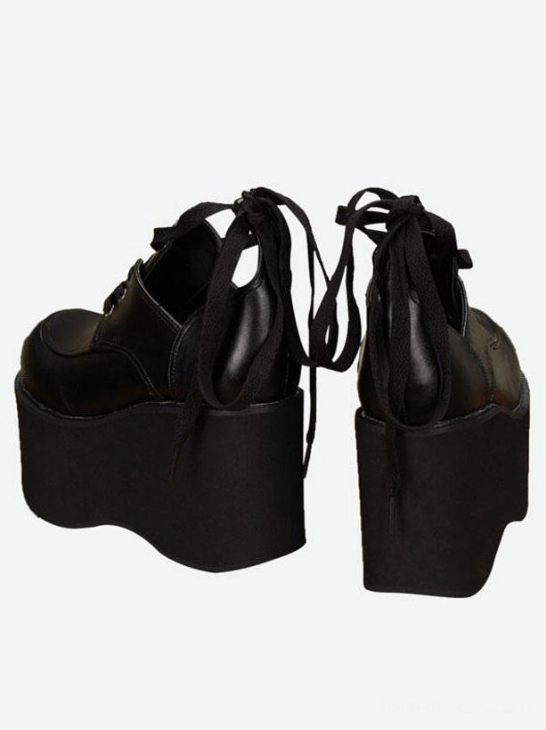 Pair of black gothic platform lolita shoes rear view showing exposed open heel thick platform sole back ribbon ties