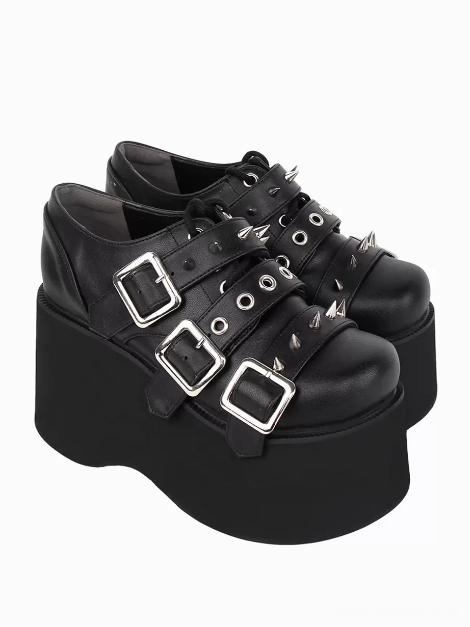 Double black gothic lolita platform pumps bottom-up oblique view showcasing thick platform sole, wedge heel construction, and underside metallic grommet details