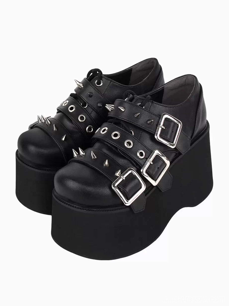 Black gothic lolita platform pumps with silver metallic grommets and studs, double-shoe oblique top-down display showing full shoe silhouette and metallic embellishments