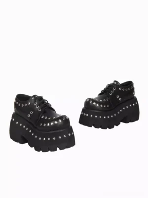 Black Gothic Lolita pumps side profile view displaying thick wedge platform sole and silver metal rivet embellishments white background