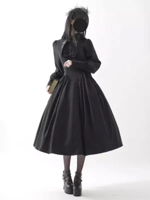 Black Gothic Lolita dress three-quarter front angle, showcasing ruffled front panel, long puff sleeves, fitted high waist, and full midi skirt silhouette with platform boots