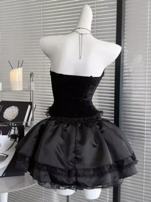 Black Gothic Lolita strapless corset dress back view displaying solid velvet bodice back neck chain decoration and layered satin skirt with lace trim details