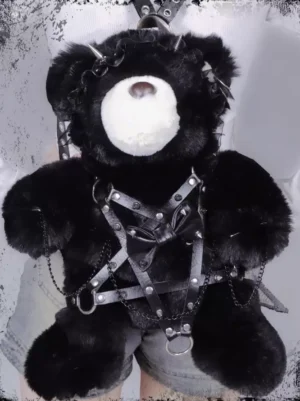 Black gothic lolita teddy bear plush backpack front view with pentagram chain harness leather bow and riveted straps worn with denim shorts outfit