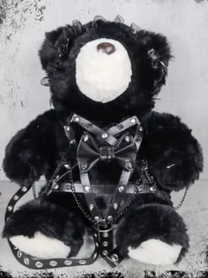 Black gothic lolita teddy bear backpack flat lay view showing pentagram riveted leather harness metal chain trim and riveted foot details