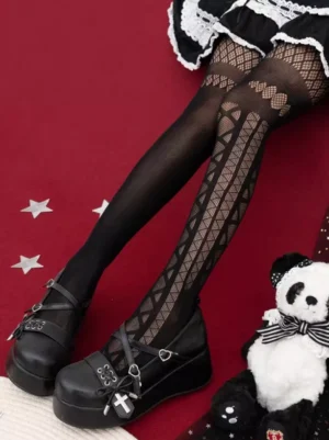 Black hollow-out gothic lolita tights with asymmetrical geometric lace patterns worn on leg from side three-quarter view angle, styled with gothic platform shoes and panda plush props on red starry backdrop