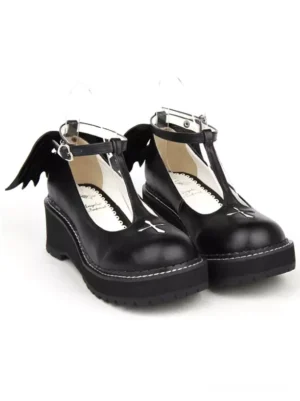 Black Gothic Lolita T-strap wedge shoes with evil wing heel detail and cross toe decoration overhead pair view white background