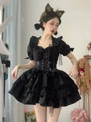 Black gothic lolita dress set three-quarter side angle showing fitted waist with lace-up corset, shoulder floral brooch, ruffled sleeve trims, and layered ruffle skirt details