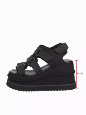 Single black gothic lolita wedge sandal side profile showcasing 10cm heel height matte suede upper and ankle buckle strap