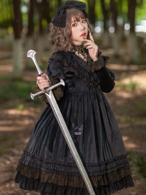 Black gothic velour lolita dress with embroidered cross print and ruffled lace trim, long puff sleeves, front view on model in woodland setting
