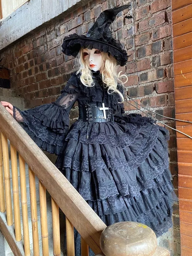 Black Gothic witch lolita dress three-quarter side shot featuring lace tiered skirt dramatic flare sleeves and cross belt decoration