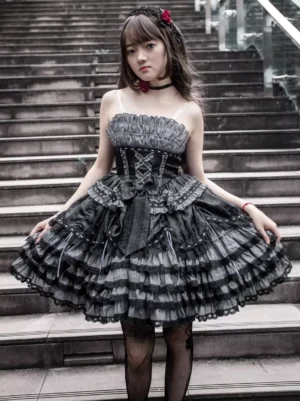 Gothic Lolita JSK dress featuring functional lace-up corset top, multi-layer ruffled skirt with fishnet stockings, outdoor stone stairway setting